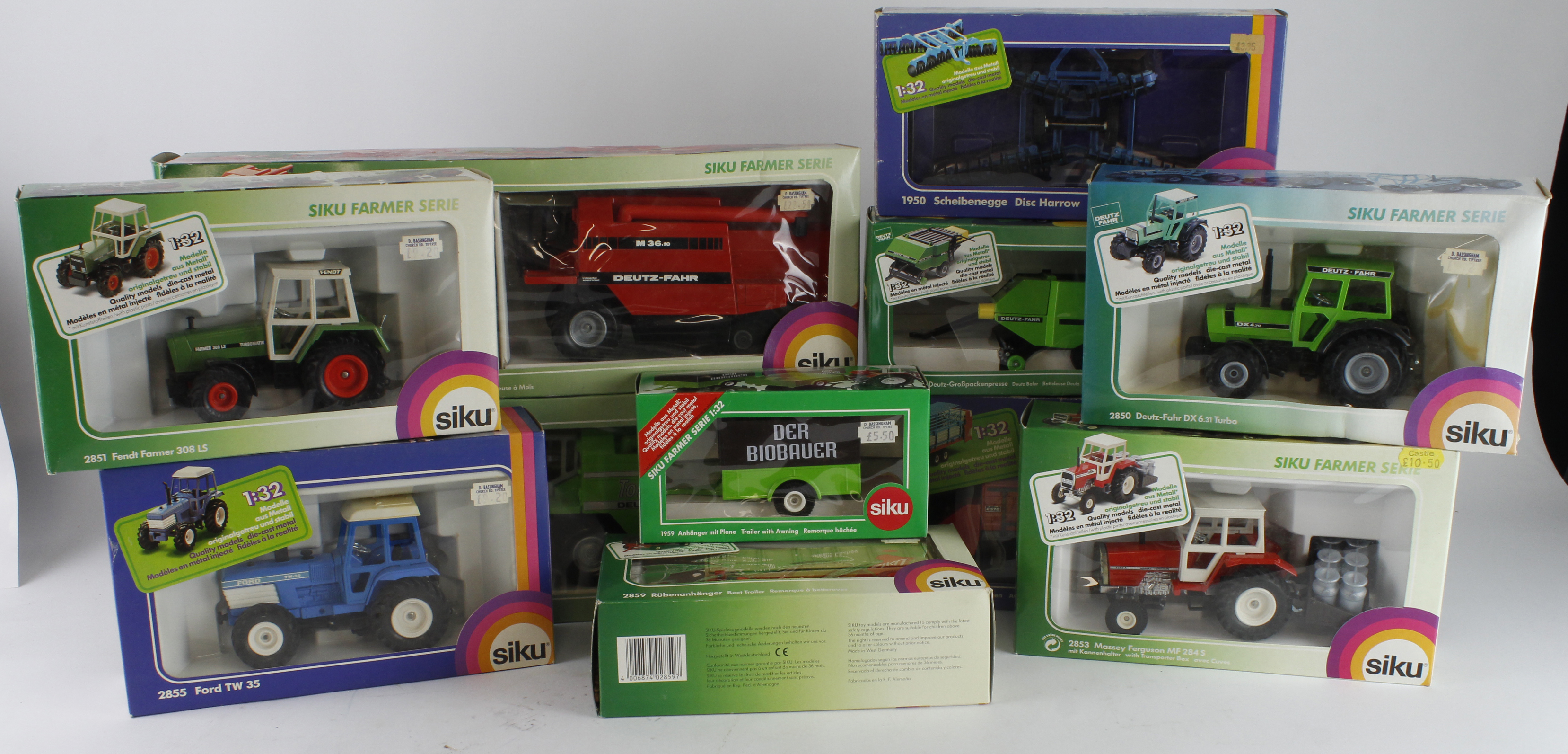 Siku. A collection of eleven boxed Siku 1:32 scale farm tractors, combine harvesters and