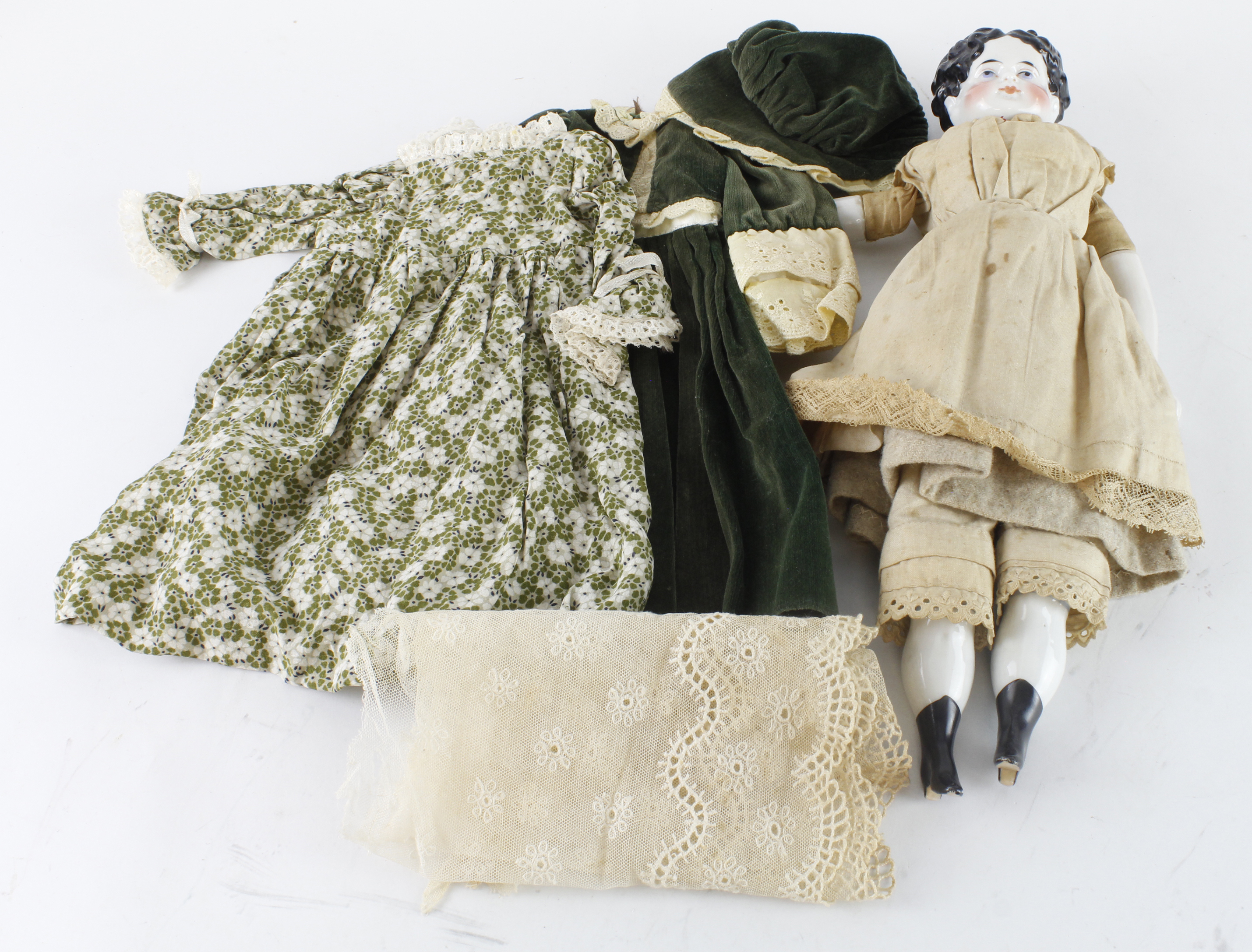 Victorian porcelain doll (possibly German), maker unknown, with a variety of clothing, length 38cm