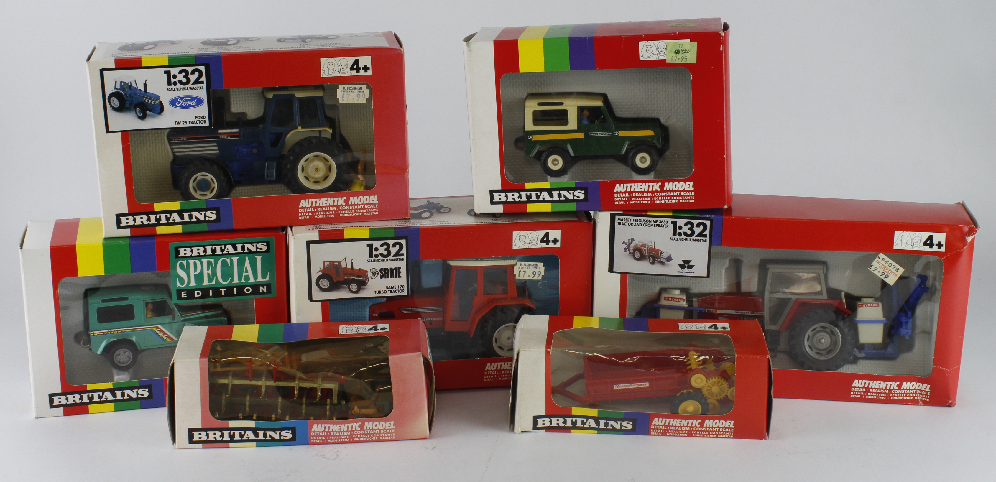 Britains. A group of seven boxed Britains 1:32 scale farm tractors and accessories, comprising 9508,
