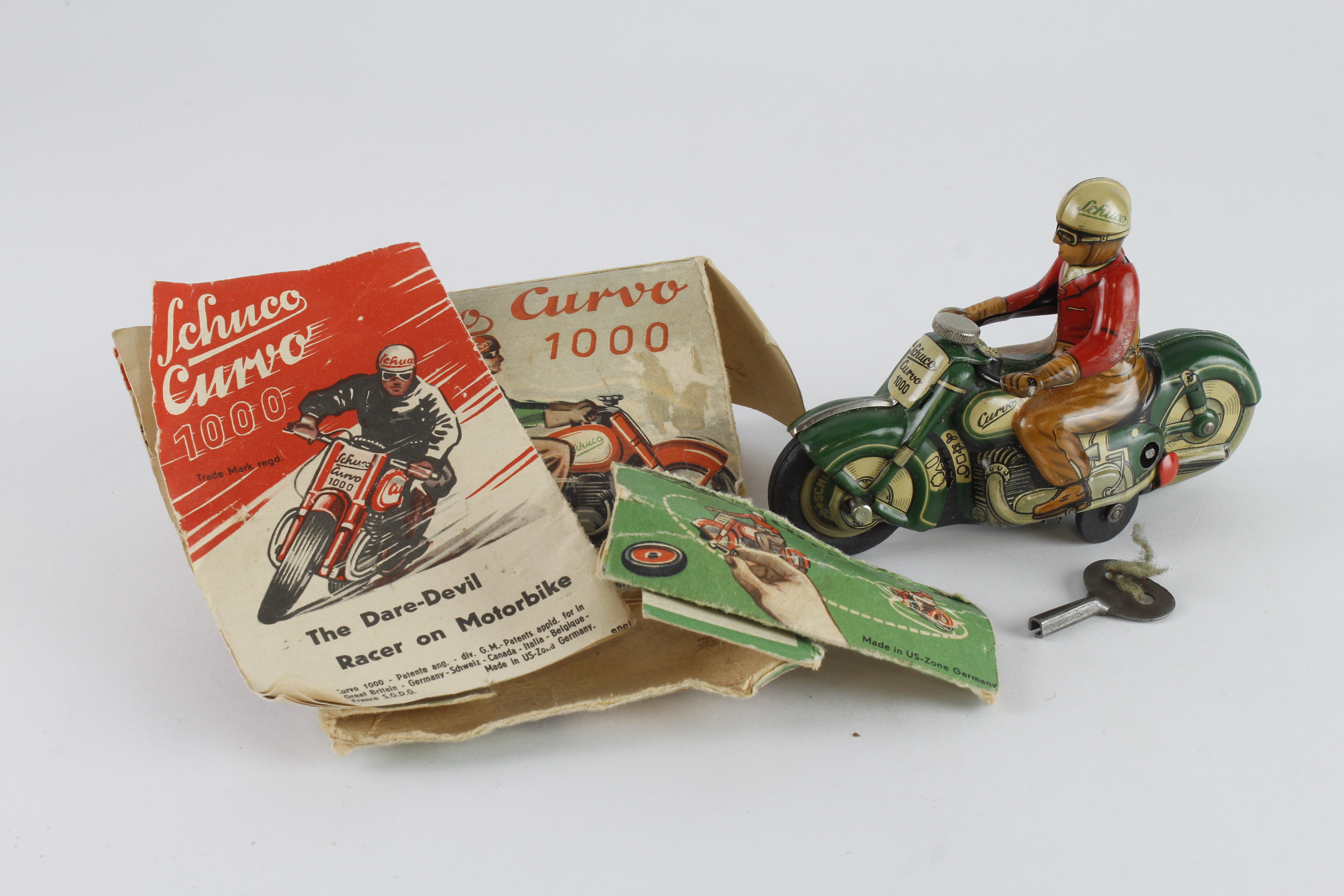 Schuco Curvo 1000 tinplate clockwork motorcycle and rider, comes with original instructions and