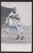 Football autograph, a b/w magazine picture showing Bobby Moore in action for West Ham with bold blue