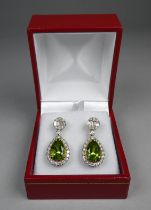 A pair of 18ct yellow gold peridot and diamond set drop earrings - the pear shaped peridots weighing