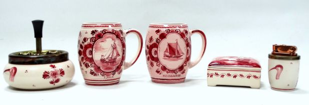 A pair of 20th century Delft mugs - decorated in a red colourway, showing sailing vessels each