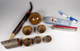 A set of graduated olivewood bowls - diameter 9cm, together with a pipe and a Hohner harmonica. (3)