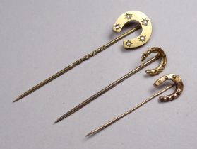 A 9ct gold and diamond mounted stock pin - in the form of a horseshoe, together with two smaller