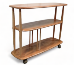 An Ercol elm and beech Baby Giraffe three tier trolley - model 361, incorporating a magazine divider