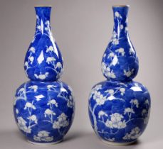 A pair of late 19th/early 20th century Chinese double gourd vases - with prunus blossom