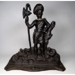 A black painted cast iron doorstop - modelled as a Scottish soldier, height 38cm.