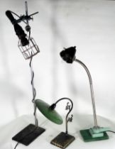 An art/industrial table lamp - the black rubber inspection lamp raised on a stand with clamps,