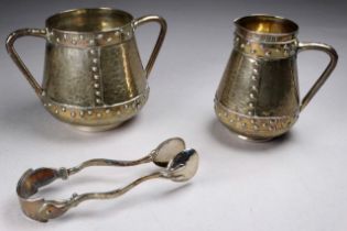 A silver sucrier, a cream jug and sugar nips - Birmingham 1909, planished with riveted bands, weight