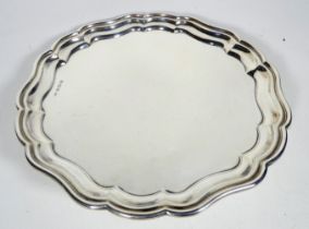 A silver tray - Birmingham 1936, Adolph Scott Ltd, circular with an ogee shaped edge, weight 657g.