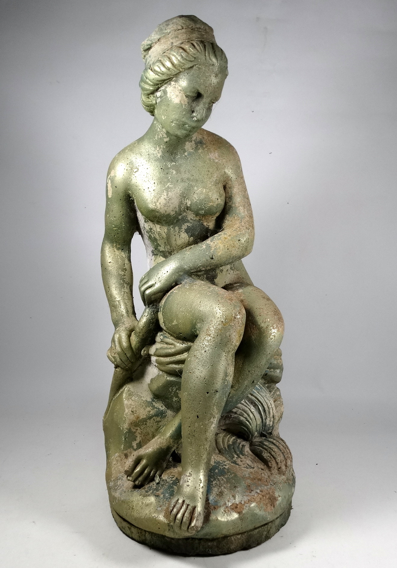 A 20th century reconstituted stone figure of a seated lady - later painted, height 61cm.