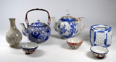 An early 20th century blue and white teapot - decorated with cherry blossom, height 15cm, together