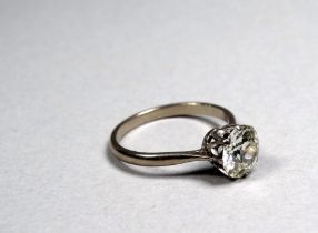 A white gold solitaire diamond ring - the brilliant cut stone claw set with pierced shoulders, the