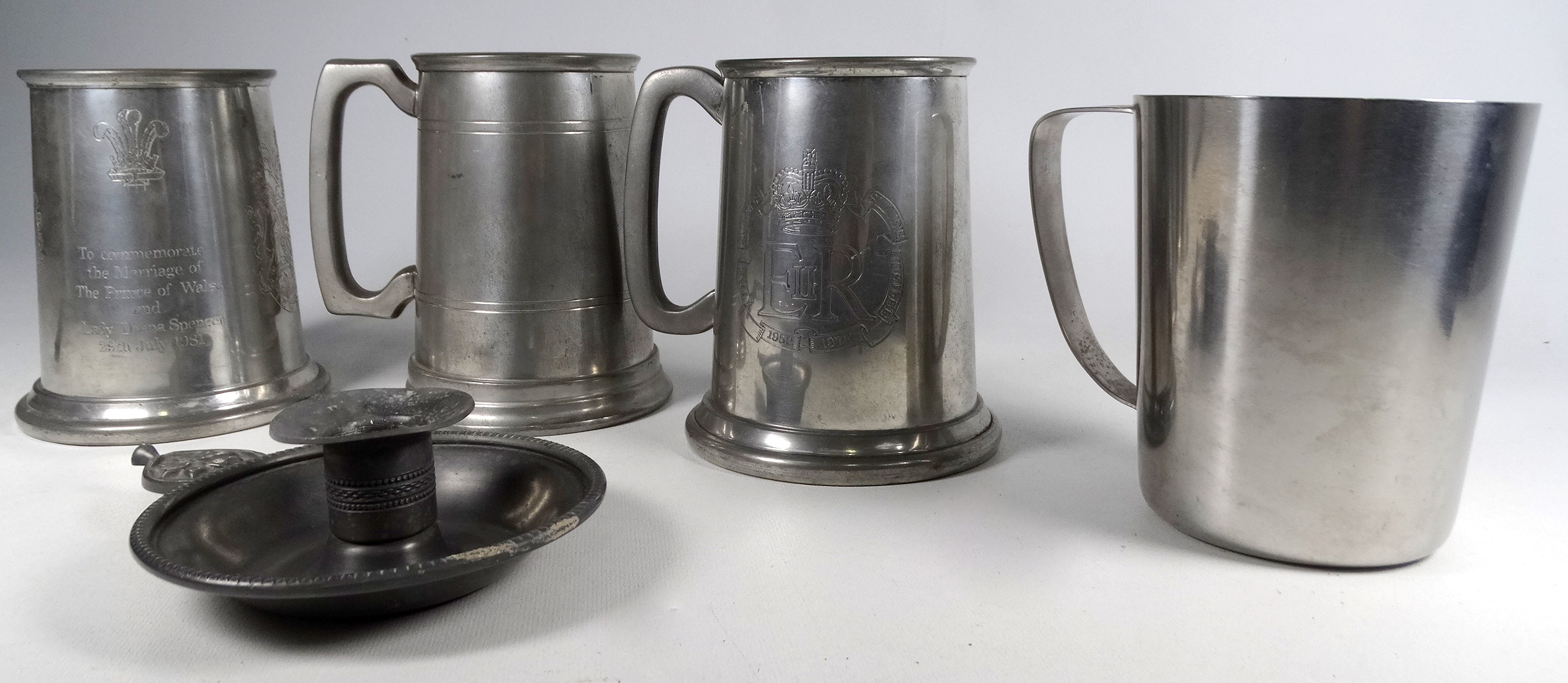 A pewter chamberstick - together with three pewter tankards and a steel tankard. (5) - Image 2 of 5