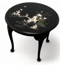 An early 20th century chinoiserie table - the circular top decorated with figures beside a bridge,