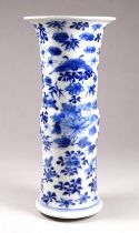 A Chinese blue and white gu shaped vase - decorated with flowers and bamboo, four character mark