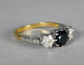 An 18ct gold three stone sapphire and diamond ring - the brilliant cut stones claw set in