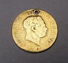 A George III half sovereign, dated 1817, drilled and rubbed.