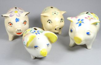 An Arthur Wood pottery piggy bank - decorated with blue, pink, and yellow flowers, width 19cm,