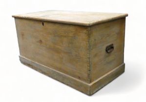 A large 19th century pine trunk - of dovetail construction, the rectangular top above steel bail