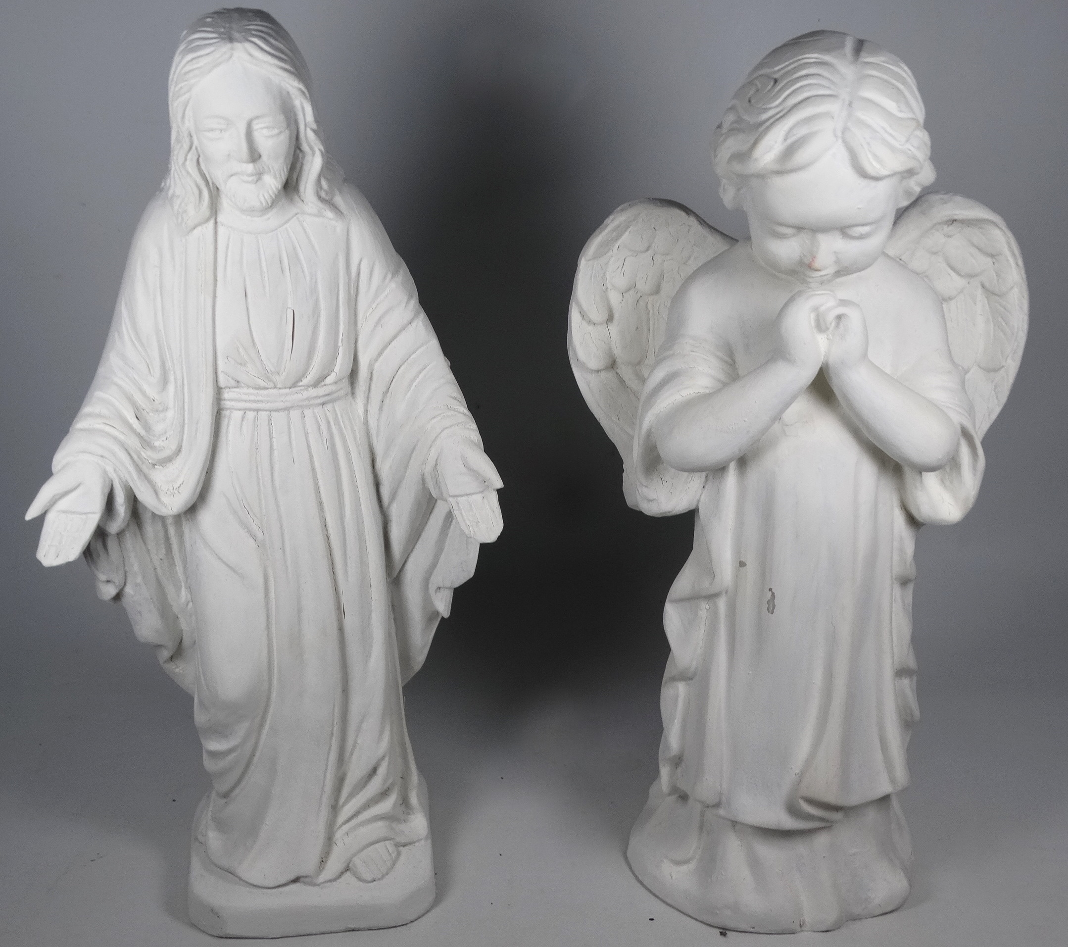 A plaster statue of an angel, height 36cm, together with a similar of Jesus, height 37cm.