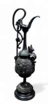 After the antique, a cast metal ewer - decorated with flowers and masks on a socle base, height