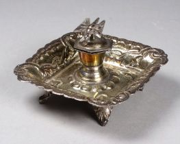A small white metal repousse ink stand - the hinged cover fitted with a butterfly on a square dished
