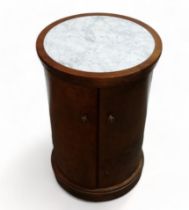 A 19th century mahogany and marble top bedside commode - circular with a pair of doors and raised on
