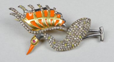 A diamond set brooch modelled as a bird - decorated with orange enamel and with a ruby eye, the