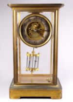 A late 19th century French lacquered brass four glass mantel clock - with silvered chapter ring