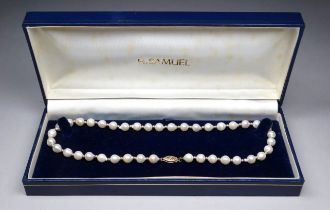 A pearl necklace with a 9ct gold clasp - of asymmetrical uniform sized beads.