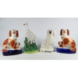 A pair of 19th century flatback figures - modelled as dogs, height 20cm, together with another and a