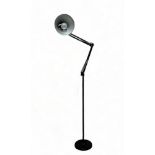 A black painted, floor standing Anglepoise style lamp.