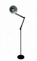 A black painted, floor standing Anglepoise style lamp.