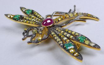 A dragonfly brooch set with a cabochon ruby, emeralds and diamonds - the ruby weighing 2.01ct