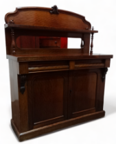 A Victorian mahogany chiffoniere - with a raised mirror back incorporating a shelf above two