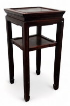 A Chinese oriental hardwood square pedestal table - the panelled top above an undertier, on square