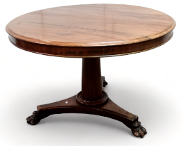 A Victorian mahogany tilt top table - the circular top above a turned tapering support and triform