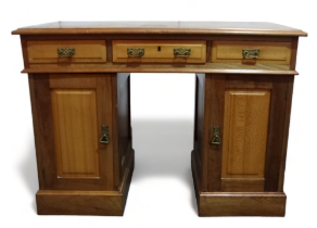 An Edwardian walnut pedestal desk - the rectangular top with green leather writing inset above an