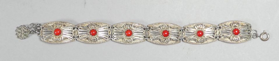An early 20th century white metal filigree bracelet - of rectangular panels set with red beads,