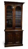 A 19th century mahogany side cabinet - the raised back with arched glazed panel doors enclosing