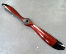 A facsimile of an early hardwood propellor - with stained natural finish and black tips, width