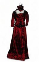 A re-enactment dress - in the form of a mid 19th century American woman, red satin and black