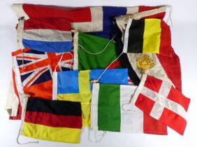 A 20th century red ensign - together with a collection of other nautical flags including Dutch,