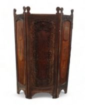 An Indian three fold hardwood screen - the central leaf carved arched panel flanked by two further