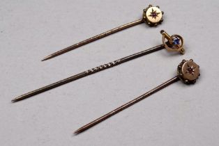 A 9ct gold sapphire set stock pin - together with two ruby set stock pins, weight 2.7g. (3)