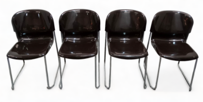 A set of four brown polycarbonate and chrome stacking chairs by Gerd Lange for Drabert - the moulded