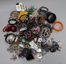 A quantity of costume jewellery - including bangles, earrings and brooches. (qty)