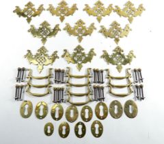 A quantity of 19th century brass escutcheons and handles - pierced with swan neck handles,